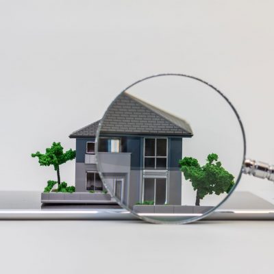 house miniature model on tablet pc and magnifying glass, searchi