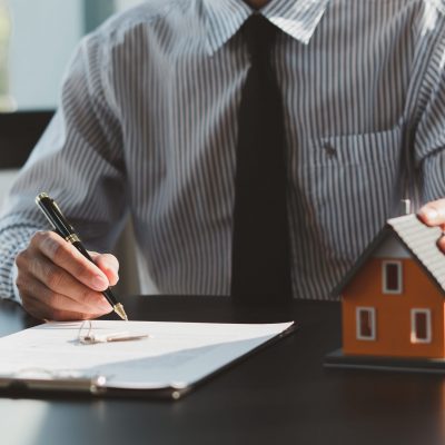 Buying a Home or Insurance, an insurance agent explains the lease agreement to a client before making a contract. Mortgage loan approval home loan and insurance concept.